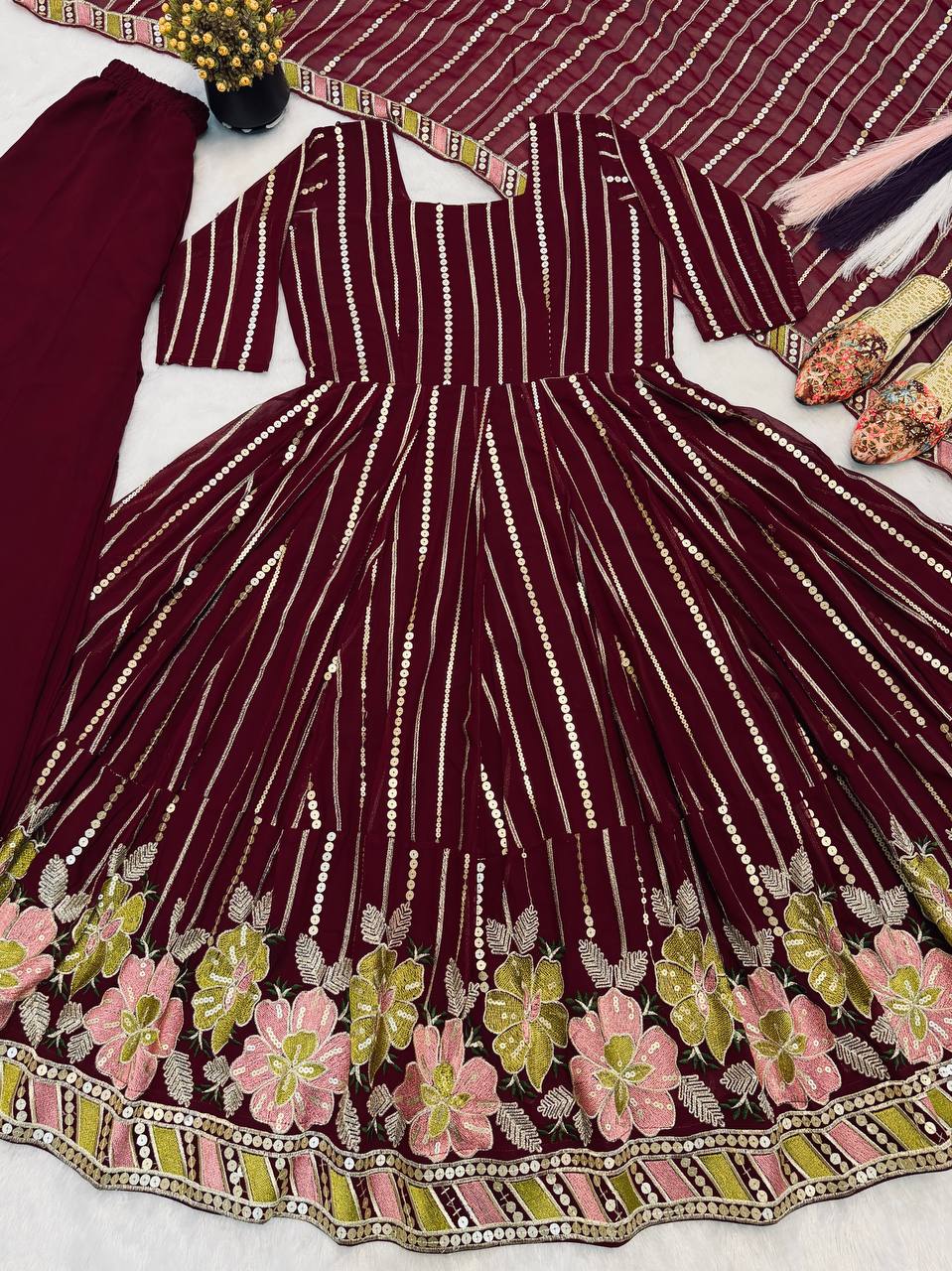 Majestic Maroon Flared Anarkali Suit Set Adorned with Luminous Sequin Stripes and an Ornate Floral Embroidered Hemline